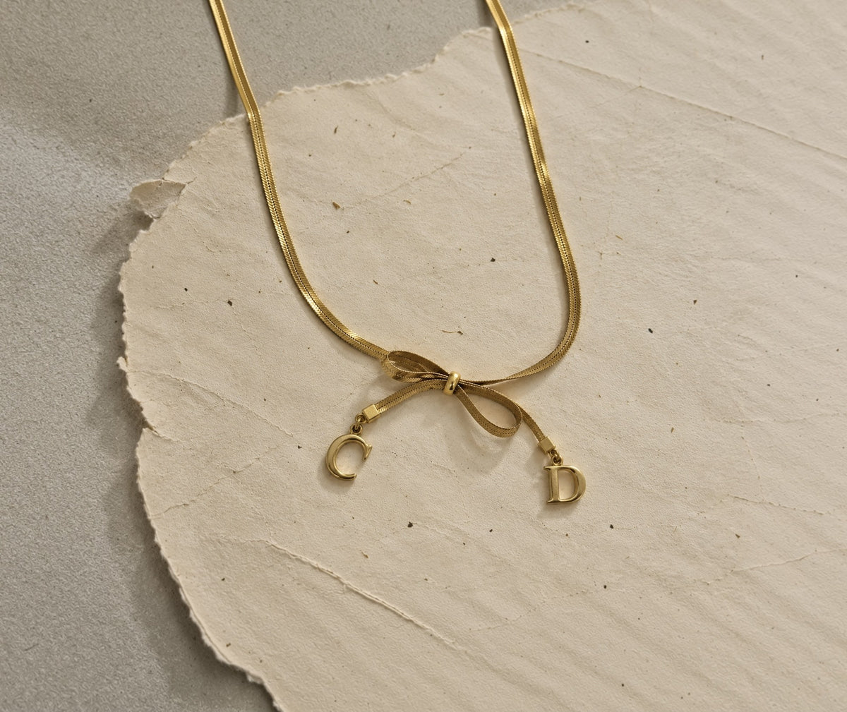 Bow necklace with C and D charms